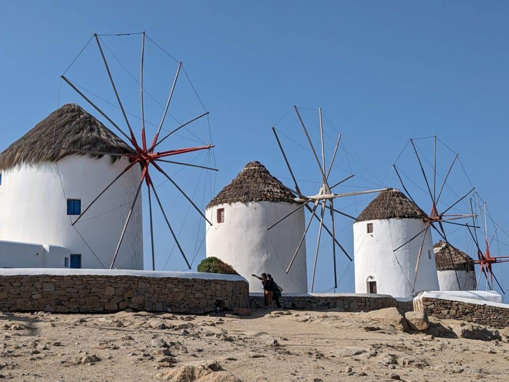 White windmills in Mykonos Greece during the day